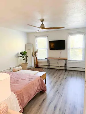 a bedroom with a bed and a flat screen tv at Modern Escape in Phoenixville, 4 Guests, Parking in Phoenixville