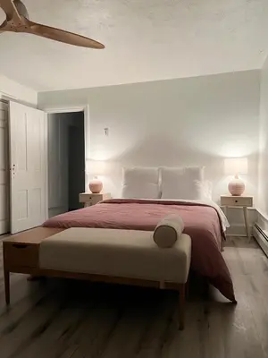 a bedroom with a large bed with red sheets and white pillows at Modern Escape in Phoenixville, 4 Guests, Parking in Phoenixville