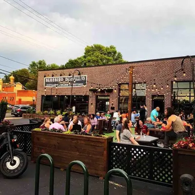 a group of people sitting outside of a restaurant at Chic Phoenixville Retreat With Parking in Phoenixville