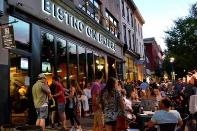 a crowd of people standing outside of a store at Chic Phoenixville Retreat With Parking in Phoenixville