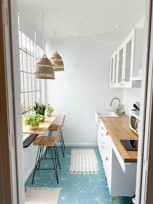 a kitchen with white cabinets and blue flooring at Queen Bed, Luxury Studio with Balcony in Phoenixville