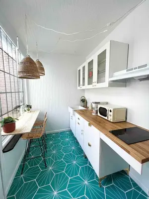 a kitchen with white cabinets and a blue floor at Queen Bed, Luxury Studio with Balcony in Phoenixville