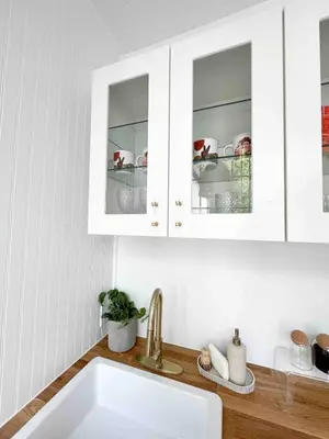 a kitchen with white cabinets and a sink at Queen Bed, Luxury Studio with Balcony in Phoenixville