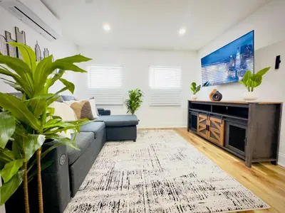 a living room with a couch and a tv at Cozy 1BR in Philly and Rain Shower in Philadelphia