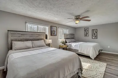 a bedroom with two beds and a ceiling fan at Cabin in Lakeside Community! Poconos Getaway in Albrightsville