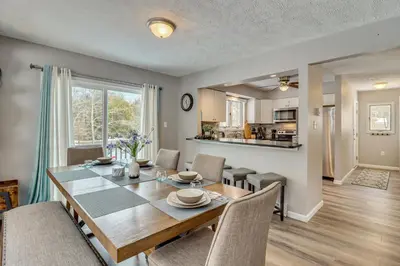 a dining room and living room with a table and chairs at Cabin in Lakeside Community! Poconos Getaway in Albrightsville