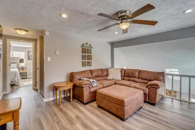 a living room with a couch and a ceiling fan at Cabin in Lakeside Community! Poconos Getaway in Albrightsville