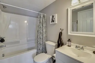 a bathroom with a toilet and a sink and a tub at Cabin in Lakeside Community! Poconos Getaway in Albrightsville