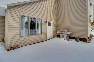 a side of a house with a snow covered driveway at Cabin in Lakeside Community! Poconos Getaway in Albrightsville