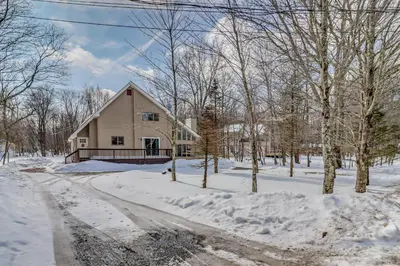 a house in the snow with a driveway at Cabin in Lakeside Community! Poconos Getaway in Albrightsville