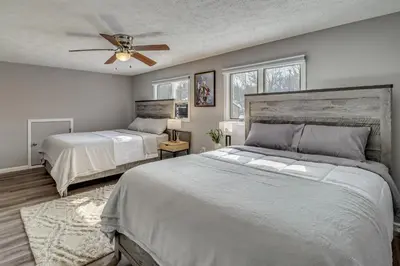 a bedroom with two beds and a ceiling fan at Cabin in Lakeside Community! Poconos Getaway in Albrightsville