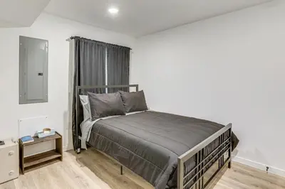 a bedroom with a bed in a white room at 2 Mi to The Met Philadelphia Home with Rooftop Deck in Philadelphia