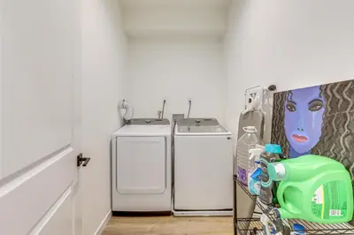 a laundry room with two washer and dryer at 2 Mi to The Met Philadelphia Home with Rooftop Deck in Philadelphia