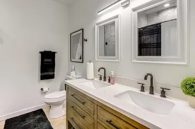 a white bathroom with a sink and a toilet at 2 Mi to The Met Philadelphia Home with Rooftop Deck in Philadelphia