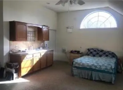 a kitchen with a bed and a sink and a window at Caribbean Deck Estate in Effort
