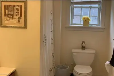a bathroom with a toilet and a window at Caribbean Deck Estate in Effort