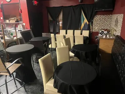 a group of tables and chairs in a restaurant at Caribbean Deck Estate in Effort