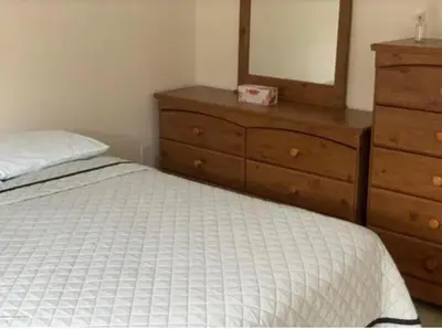 a bedroom with a bed and a dresser and a mirror at Caribbean Deck Estate in Effort