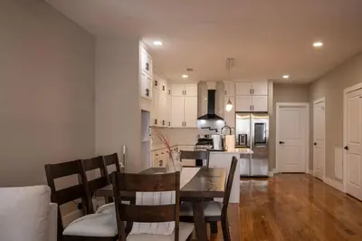 a kitchen and dining room with a table and chairs at 4BR5BA Luxury World Cup hub in North Bergen