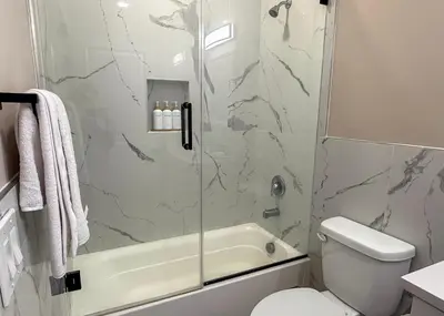 a bathroom with a shower and a toilet and a sink at 4BR5BA Luxury World Cup hub in North Bergen