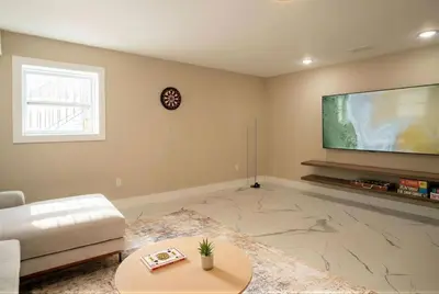 a living room with a large flat screen tv at 4BR5BA Luxury World Cup hub in North Bergen