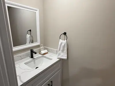 a bathroom with a white sink and a mirror at 4BR5BA Luxury World Cup hub in North Bergen