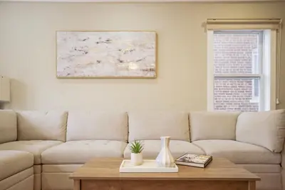 a living room with a couch and a table at 4BR5BA Luxury World Cup hub in North Bergen