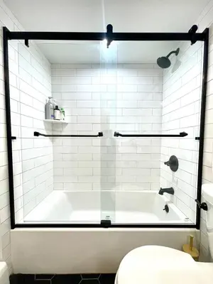 a white bathroom with a tub and a toilet at Cozy 3BR Home - Hudson Valley views near Woodbury Commons in Highland Mills