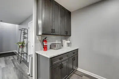 a kitchen with wooden cabinets and a counter top at Easy Commute to Philly Traveling Pros Hub! in Levittown