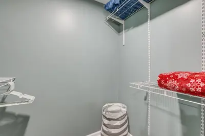 a closet with a red object on a shelf at Easy Commute to Philly Traveling Pros Hub! in Levittown