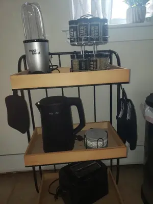a shelf with cups and other items on it at NYC Escape Easy Transit Easy Parking Quiet Area in Teaneck