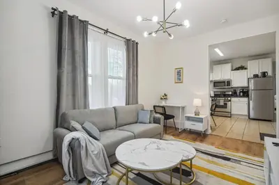 a living room with a couch and a table at NYC Escape Easy Transit Easy Parking Quiet Area in Teaneck