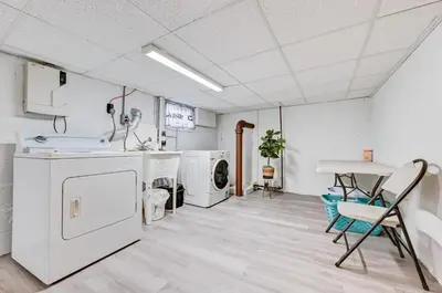 a kitchen with white appliances and a table and chairs at NYC Escape Easy Transit Easy Parking Quiet Area in Teaneck
