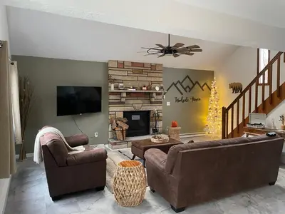 a living room with two couches and a fireplace at Woodside Haven - Game Room - Central AC - Pet Friendly in Tobyhanna