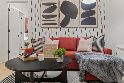 a living room with a red couch and a table at Modern 1 BR Apartment Near Center City & University City in Philadelphia