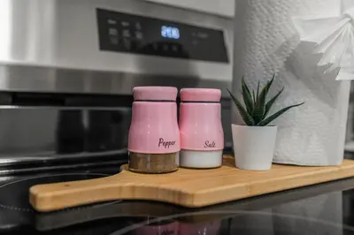 two pink bottles sitting on a wooden cutting board at Modern 1 BR Apartment Near Center City & University City in Philadelphia
