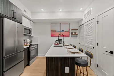 a kitchen with stainless steel appliances and a white counter top at Modern 1 BR Apartment Near Center City & University City in Philadelphia
