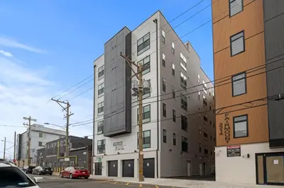 a tall building on a city street at Modern 1 BR Apartment Near Center City & University City in Philadelphia