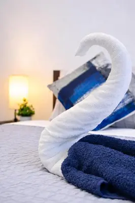 a pile of towels sitting on top of a bed at Cozy 3BR Apt in Jersey City! near NYC & Metlife! in Jersey City