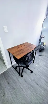 a picnic table sitting in the corner of a room at 3BR duplex near MetLife! w/ Parking! mins to NY in Jersey City