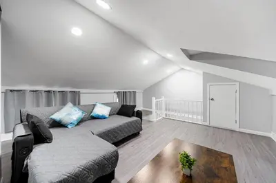 a living room with a couch and a table at 3BR duplex near MetLife! w/ Parking! mins to NY in Jersey City