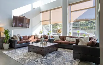 a living room with couches and a coffee table at 4-Bedroom Furnished Apartment at Temple Crossing in Philadelphia