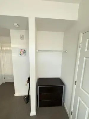 a room with a closet with a bench in it at 4-Bedroom Furnished Apartment at Temple Crossing in Philadelphia