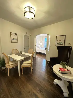 a dining room with a table and chairs and a bedroom at Comfortable - Exc Location Apt 2BD 1BA Downtown JC 12 min to NYC in Jersey City