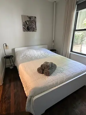 a bed with towels on it in a bedroom at Comfortable - Exc Location Apt 2BD 1BA Downtown JC 12 min to NYC in Jersey City