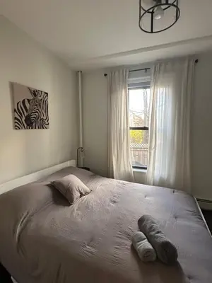 a bedroom with a bed with two towels on it at Comfortable - Exc Location Apt 2BD 1BA Downtown JC 12 min to NYC in Jersey City