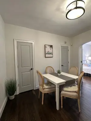 a dining room with a white table and chairs at Comfortable - Exc Location Apt 2BD 1BA Downtown JC 12 min to NYC in Jersey City