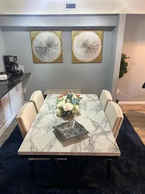 a marble table with flowers on it in a room at comfort for you in Elkins Park