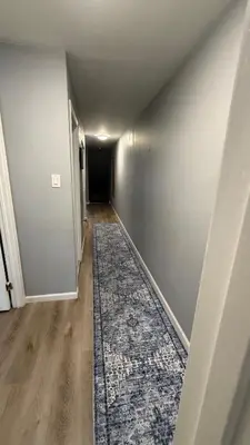 an empty hallway with a rug on the floor at comfort for you in Elkins Park