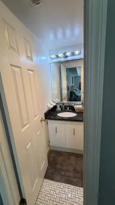 a bathroom with a sink and a mirror at comfort for you in Elkins Park